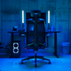 The new Vantum gaming chair parked at a desk in a room with blue accent lighting.